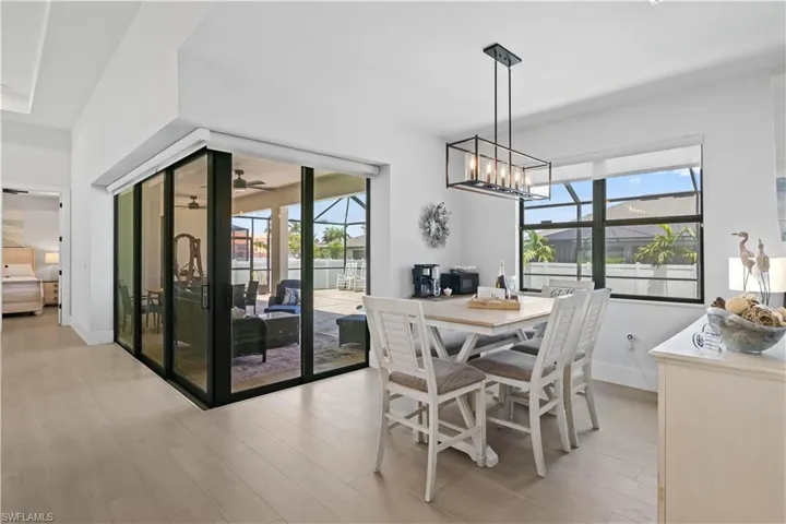 Dining room featuring light wood finished floors and a chandelier