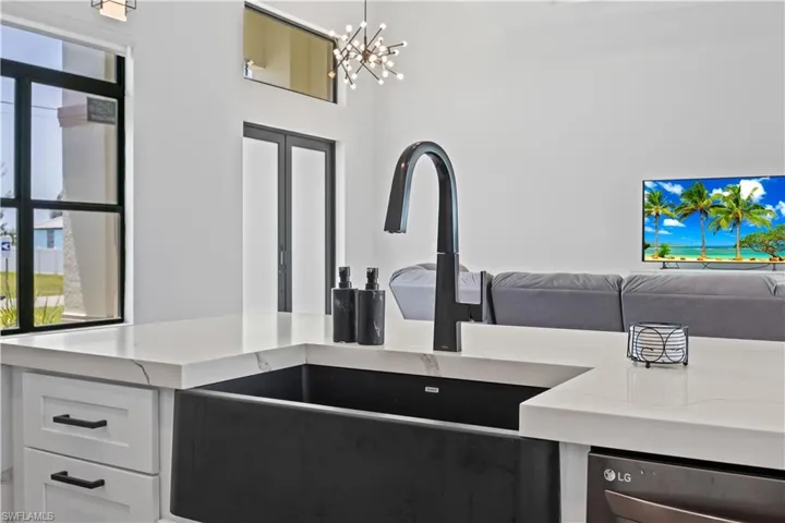 Kitchen featuring open floor plan, a chandelier, and light countertops