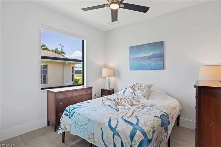 Bedroom with a ceiling fan and baseboards
