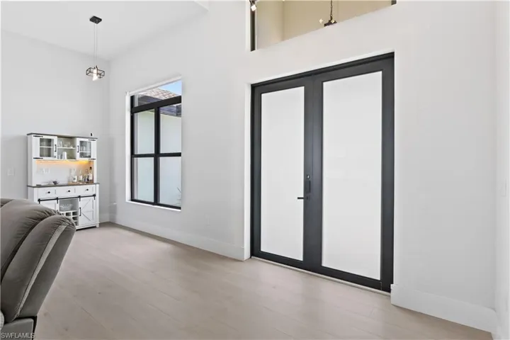 Foyer entrance featuring light wood-style floors and baseboards