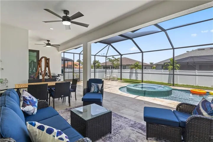 View of patio / terrace featuring an outdoor hangout area, outdoor dining area, a pool with connected hot tub, ceiling fan, and a residential view