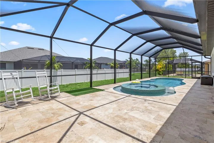 View of swimming pool featuring a residential view, a patio, and a hot tub