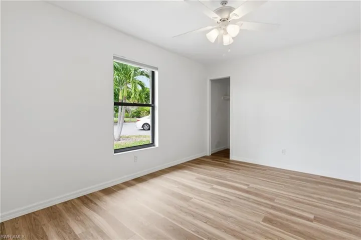 Unfurnished room with light wood finished floors and ceiling fan