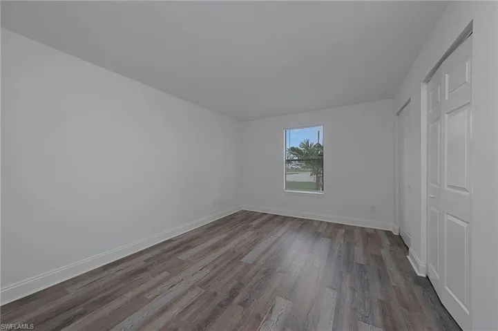 Unfurnished bedroom featuring a closet and hardwood / wood-style flooring