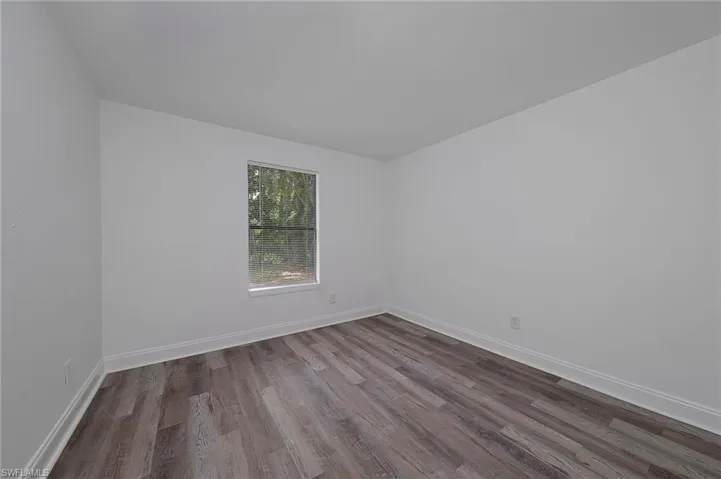 Unfurnished room with hardwood / wood-style floors