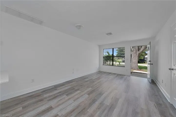 Unfurnished room with hardwood / wood-style floors