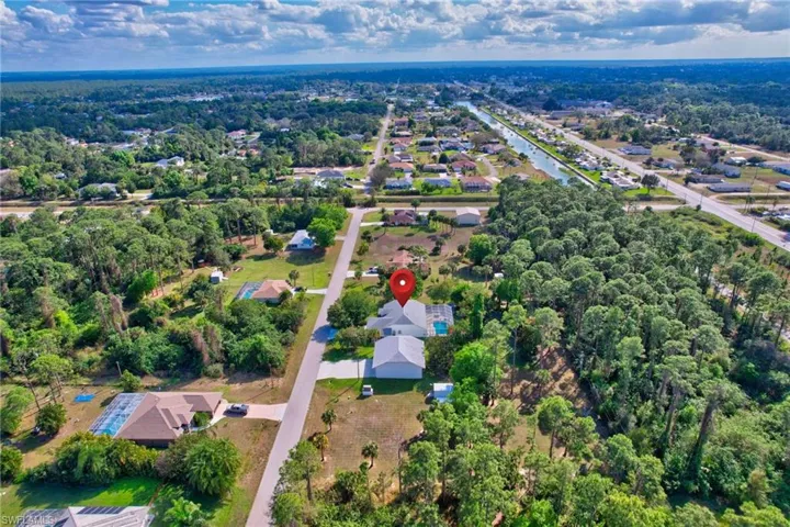 Aerial perspective showcasing a residential property with a light-colored roof