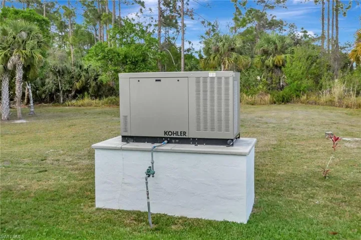 Kohler generator installed on a stucco-finished concrete pad