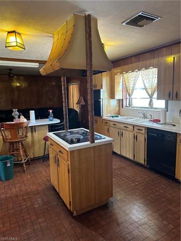 Kitchen with island stove.