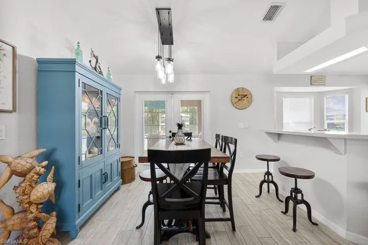 Dining room featuring french doors and light wood-style ceramic tile floors