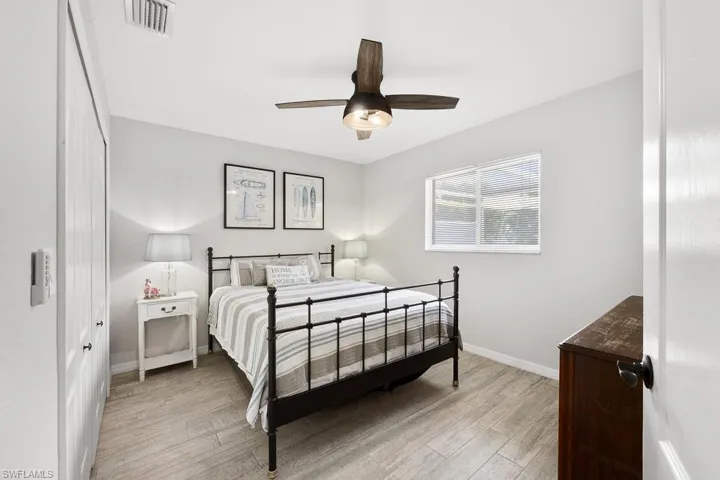 Bedroom with light wood-style floors and a ceiling fan