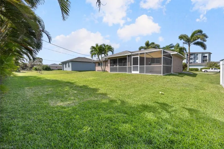 View of green lawn featuring an expansive lanai and room for your custom pool