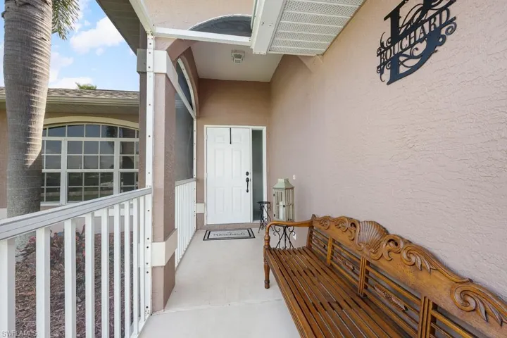 Property entrance featuring stucco siding