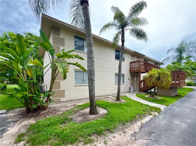 View of front of property with a wooden deck