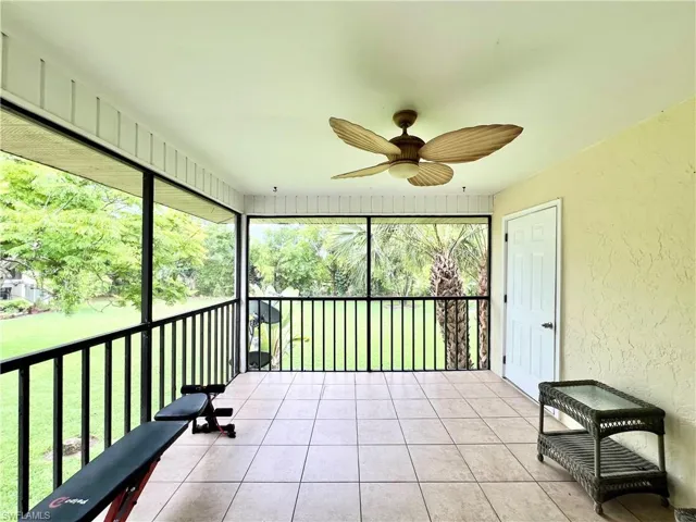 Unfurnished sunroom featuring ceiling fan