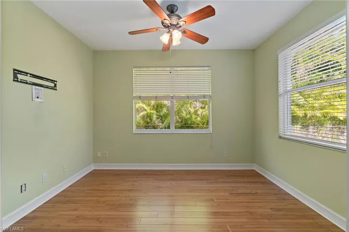 Office/Den featuring light wood floors, plenty of natural light, and a ceiling fan