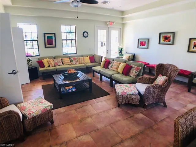 Living room with ceiling fan and french doors