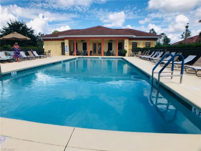 View of pool featuring ceiling fan and a patio