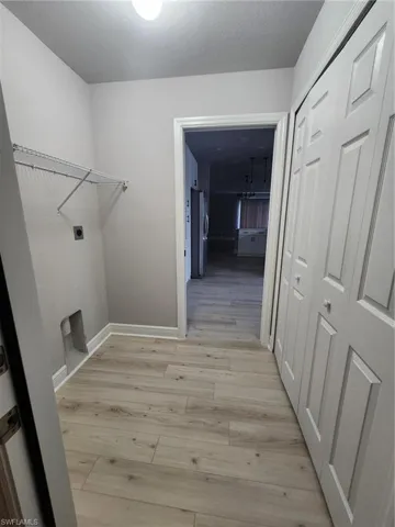 Washroom featuring light hardwood / wood-style floors and electric dryer hookup
