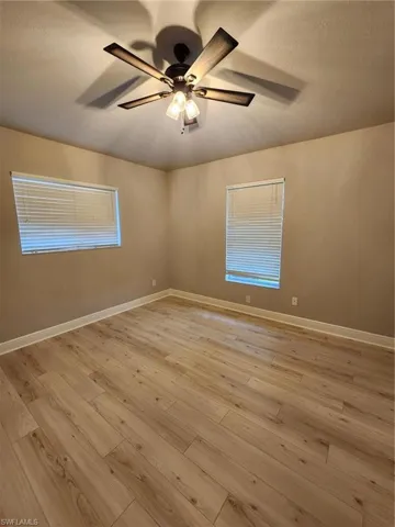 Unfurnished room featuring ceiling fan and light hardwood / wood-style flooring