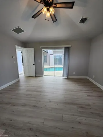 Unfurnished room featuring ceiling fan and hardwood / wood-style floors