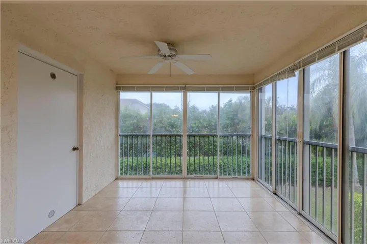 Unfurnished sunroom featuring ceiling fan