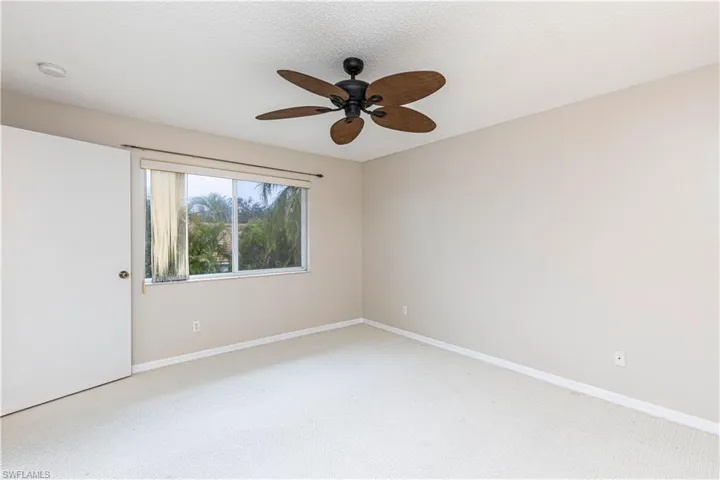 Spare room featuring carpet floors and ceiling fan