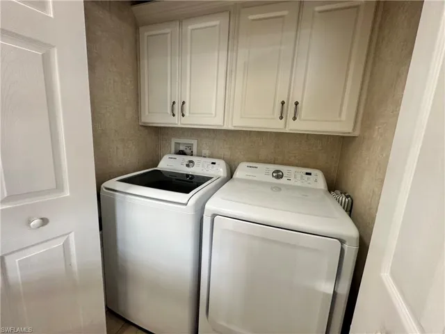 Laundry room with cabinet space and washing machine and clothes dryer