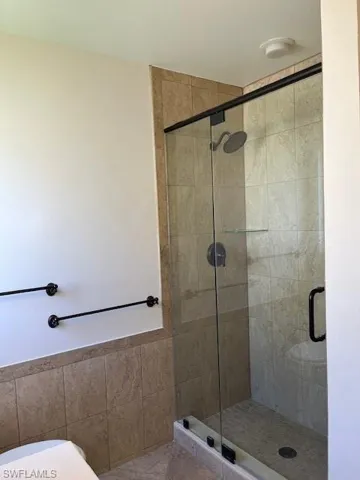 Bathroom with a shower with shower door