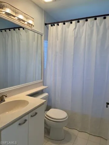 Bathroom featuring tile patterned floors, vanity, and toilet