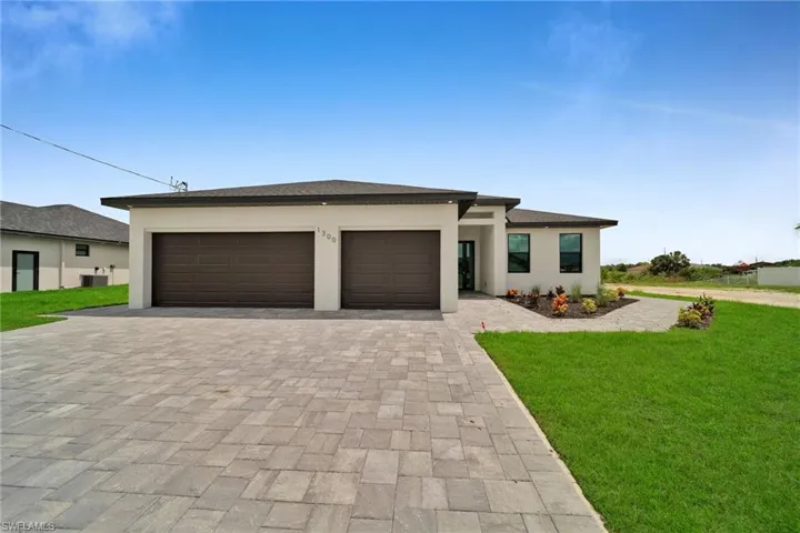 Prairie-style house featuring a garage and a front yard