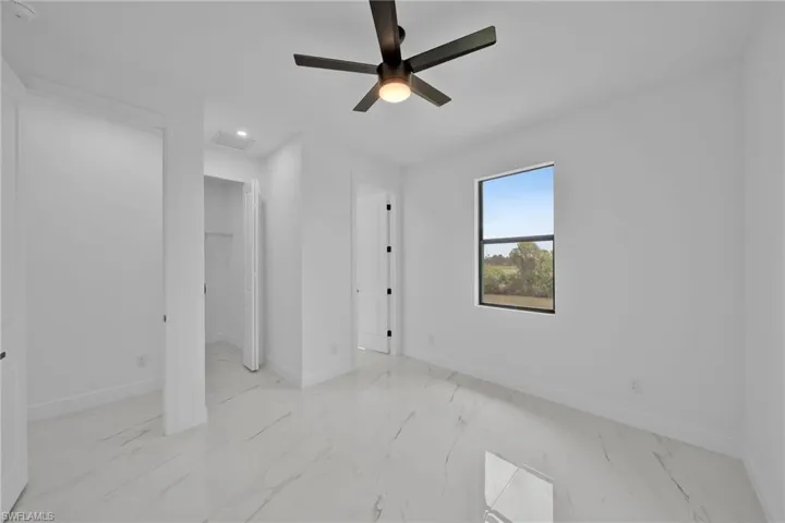 Unfurnished room featuring ceiling fan