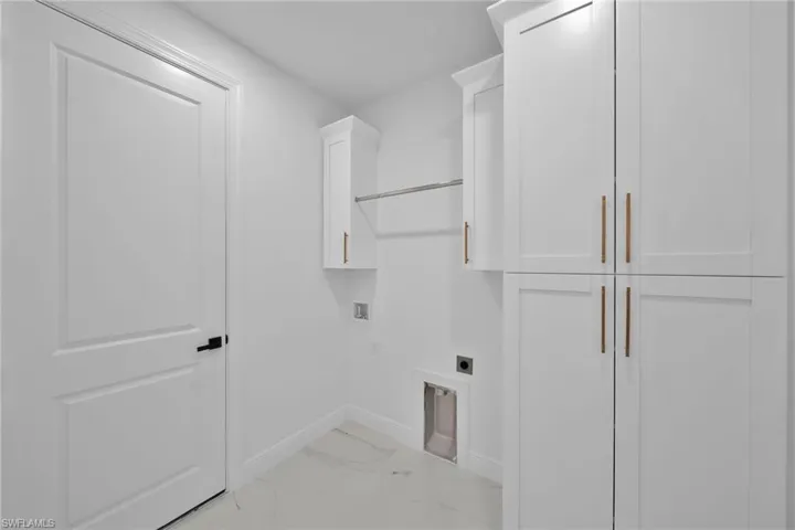 Laundry room with washer hookup, electric dryer hookup, and cabinets