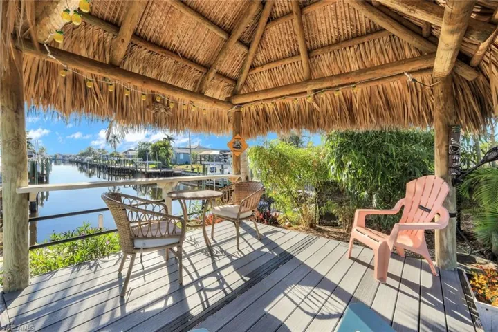 Wooden terrace featuring a gazebo and a water view