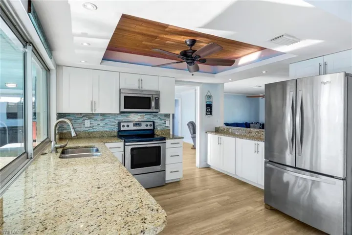 Kitchen featuring a sink, a raised ceiling, visible vents, and stainless steel appliances