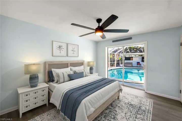 Bedroom featuring visible vents, baseboards, ceiling fan, and dark wood-style flooring