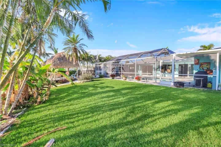View of yard with a gazebo, a lanai, and an outdoor pool