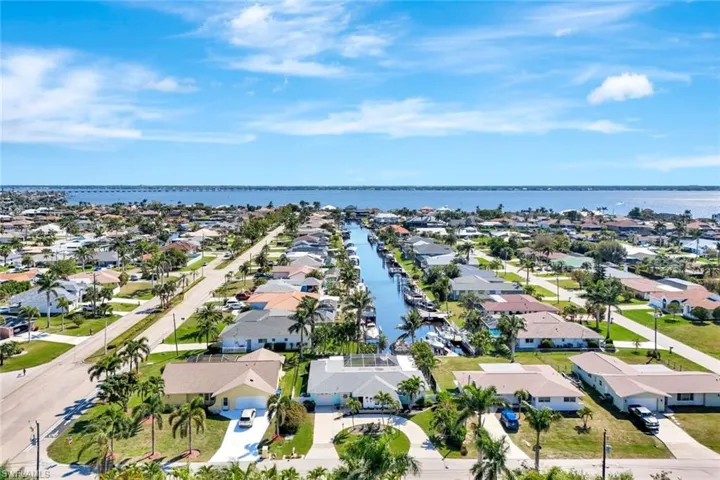 Drone / aerial view with a residential view and a water view