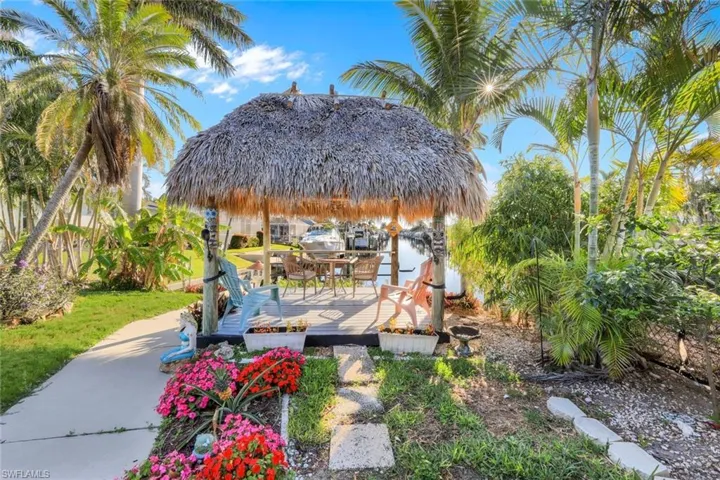 Wooden terrace featuring a gazebo and a water view