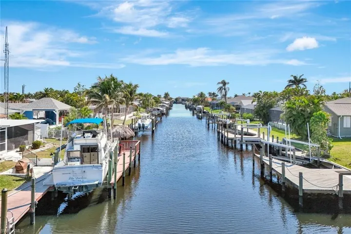 Dock area featuring a residential view, a water view, and boat lift