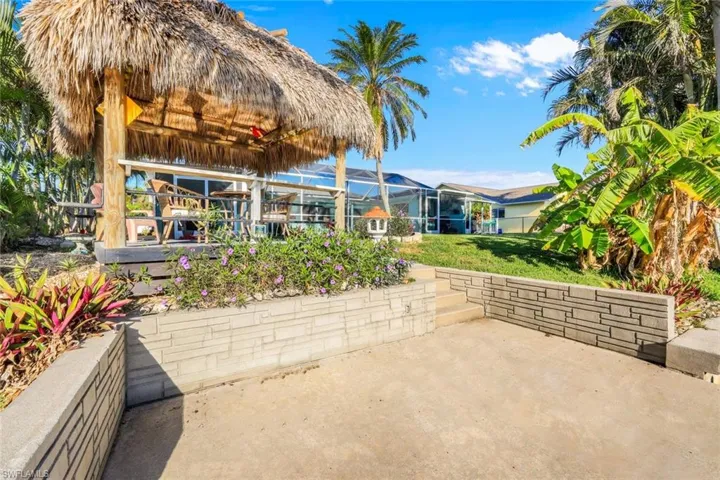 View of patio with glass enclosure and a gazebo
