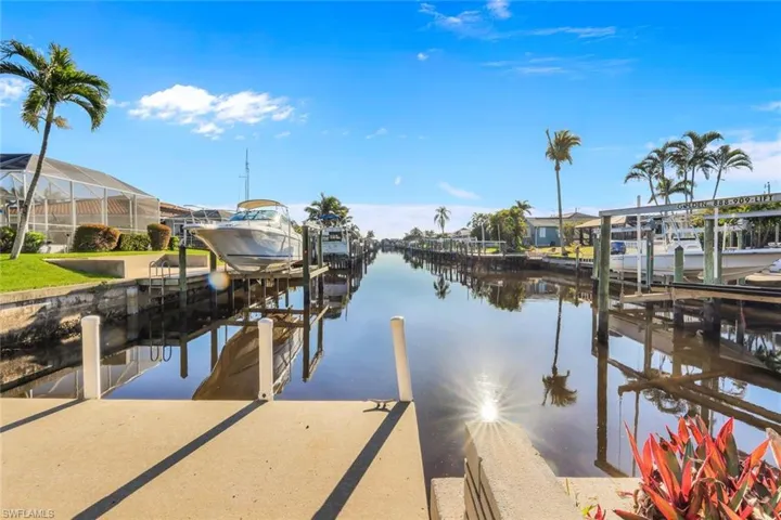 Dock area featuring boat lift and a water view
