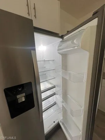 Kitchen view of stainless steel fridge