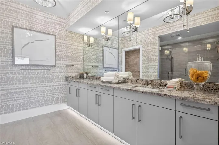 Master suite bathroom has dual vanity with undermount sinks and extensive granite countertops