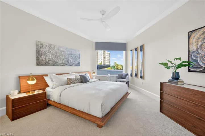 Bedroom 3 features light carpeting , coastal contemporary decor , large window for natural lighting