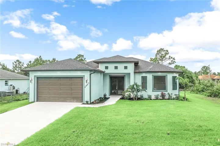 Prairie-style house with a front yard and a garage