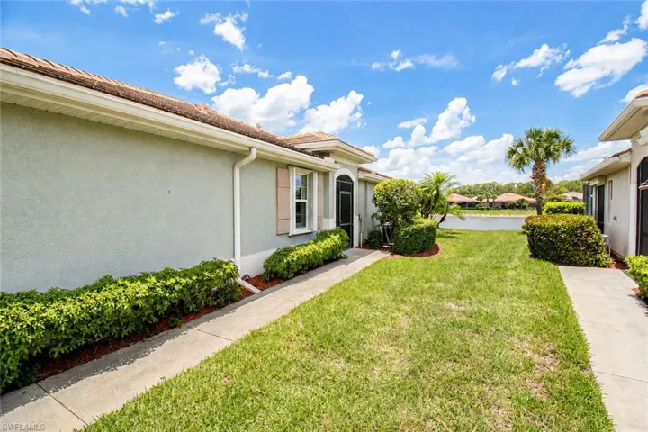 WIDE SIDE YARD AND WALK-UP TO ENTRANCE OF HOME.
