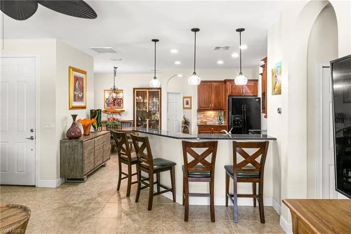 EAT-IN KITCHEN BAR ALLOWS FOR CONVERSATION WITH GUESTS WHILE YOU COOK