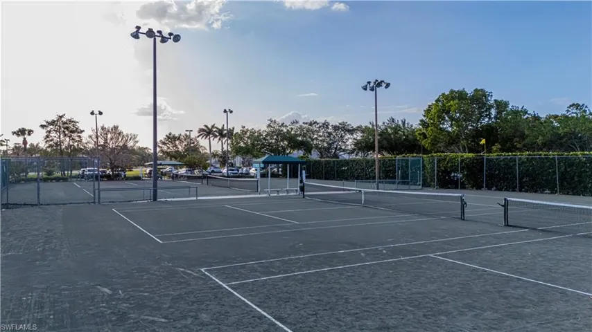 View of tennis court featuring fence