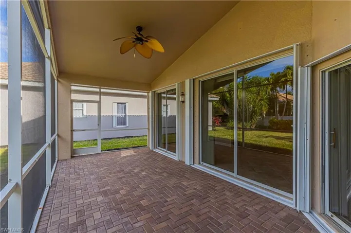 Unfurnished sunroom featuring ceiling fan